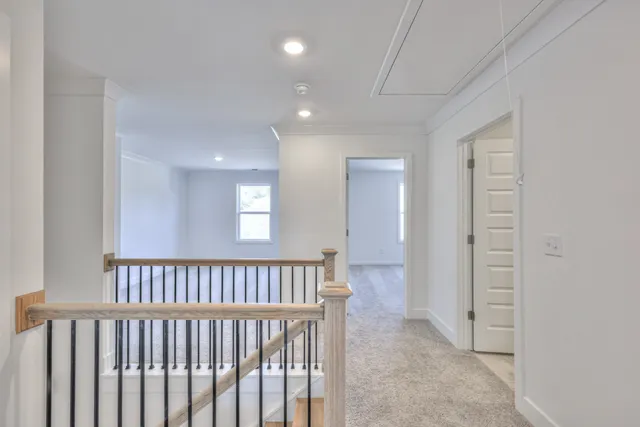 a view of hallway with a window and a livingroom
