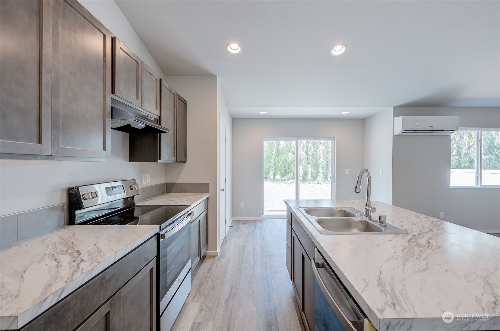 101 Walnut Street Tieton, WA 98947 - Photo 11 of 27 a kitchen with granite countertop stainless steel appliances sink stove microwave and cabinets