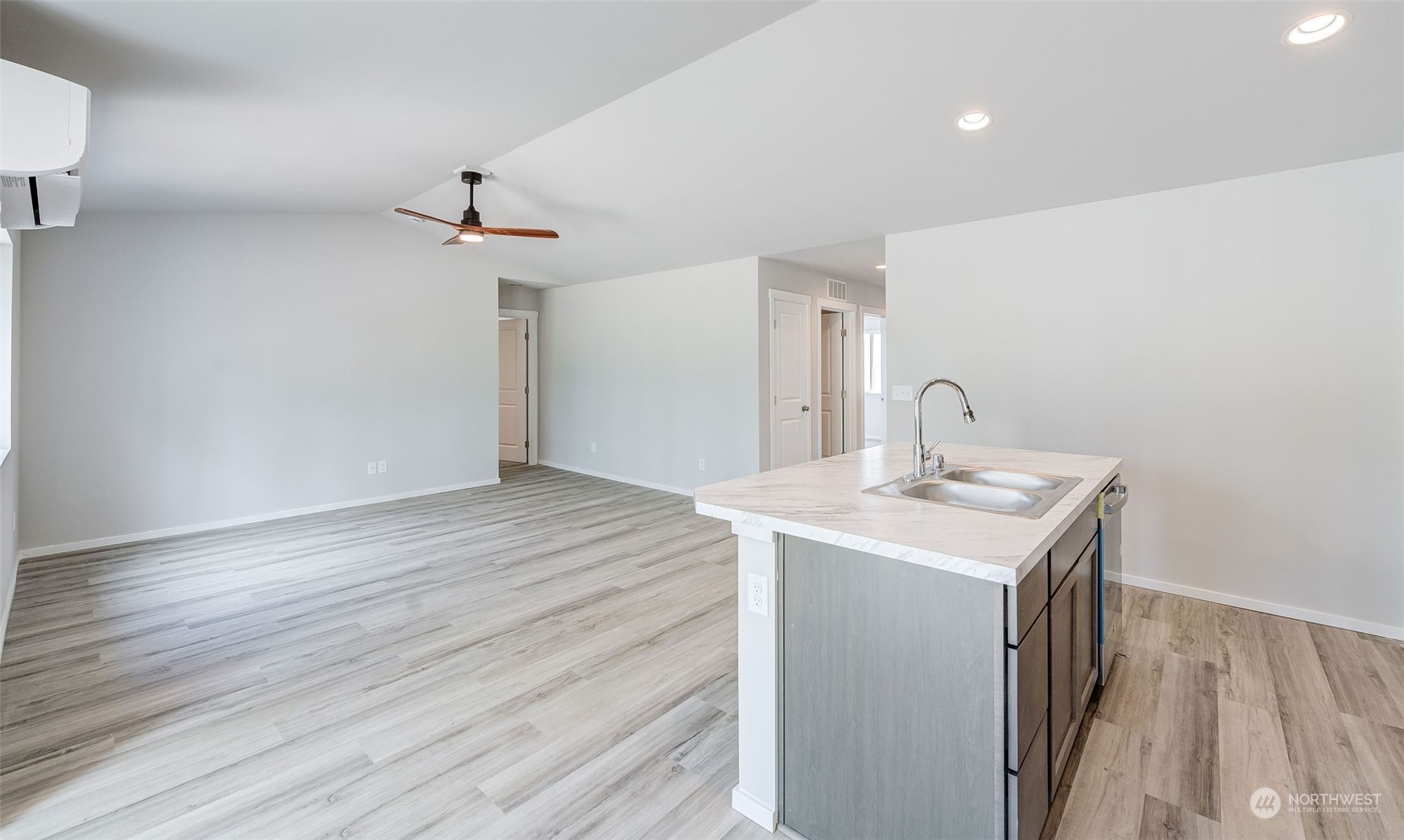 101 Walnut Street Tieton, WA 98947 - Photo 14 of 27 a room with a sink a mirror and wooden floor