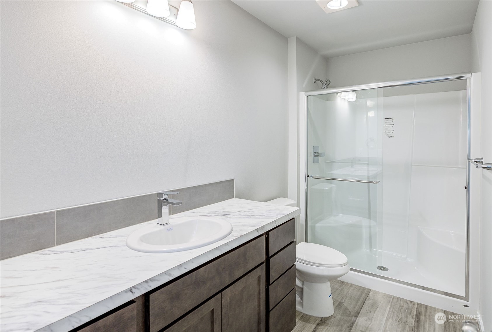101 Walnut Street Tieton, WA 98947 - Photo 20 of 27 a bathroom with a granite countertop sink toilet and shower