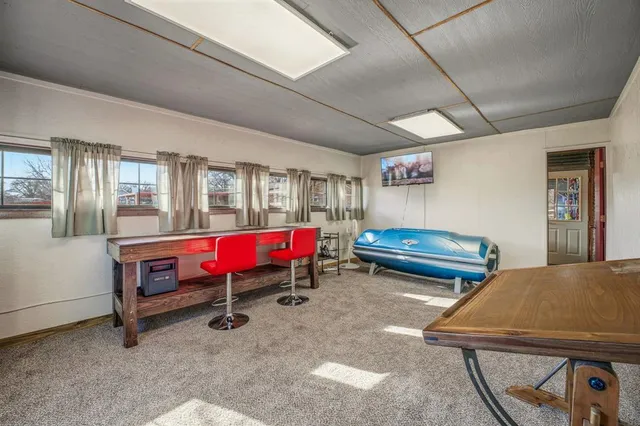 a living room with furniture and kitchen tables