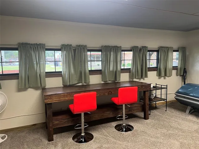 a room with lots of wooden furniture and a floor to ceiling window