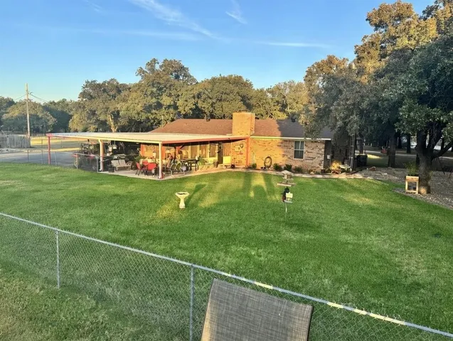 a view of a backyard with sitting area