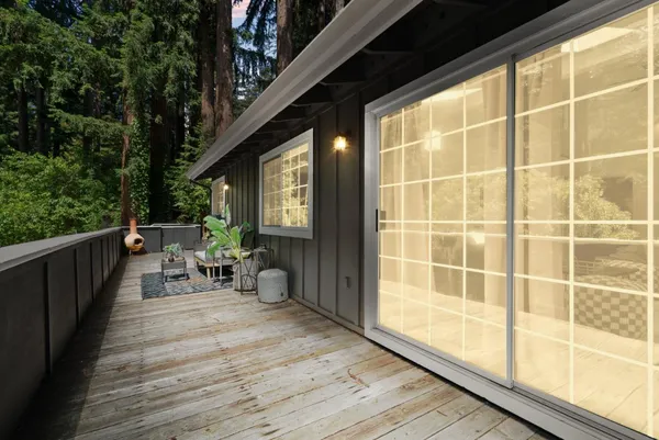 a view of a deck with wooden floor and furniture