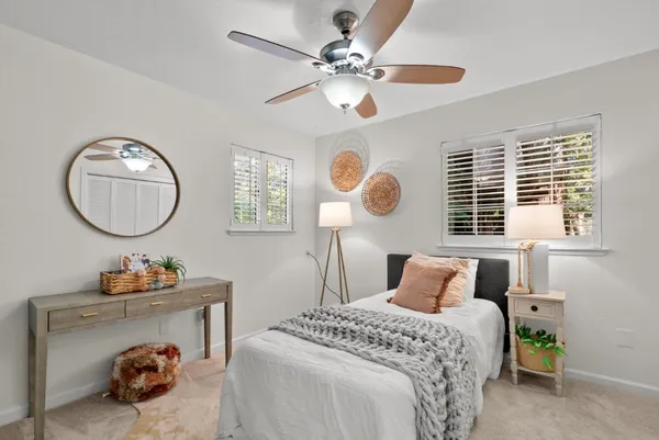 a bedroom with bed and a chandelier
