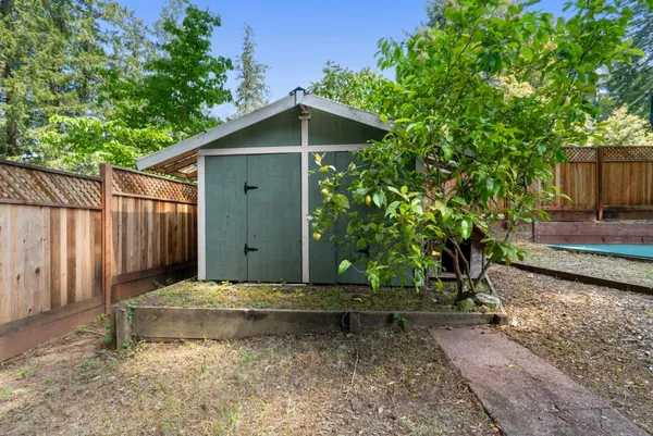 a backyard of a house with wooden fence