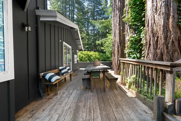 a view of balcony with wooden floor and outdoor seating