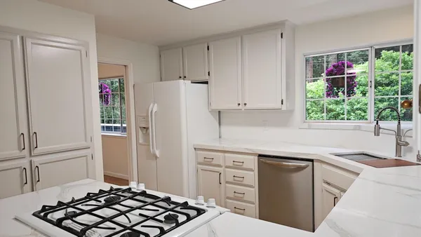a kitchen with stainless steel appliances a refrigerator sink and stove