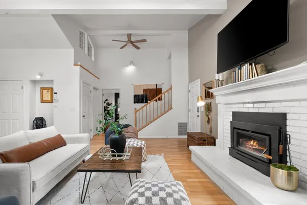 a living room with furniture a flat screen tv and a fireplace