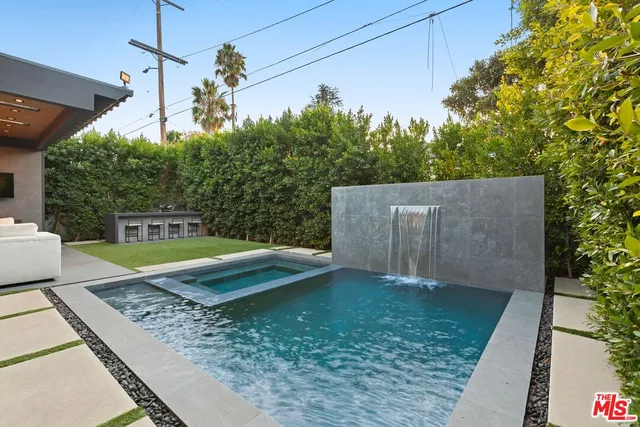 a house view with a swimming pool table and chairs