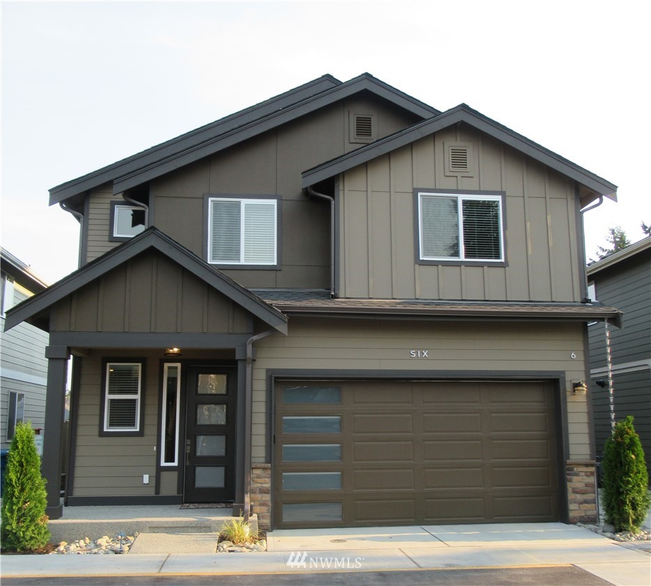 8609 244th Street Southwest, Unit 6 Edmonds, WA 98026 - Photo 1 of 27 a front view of a house with garage