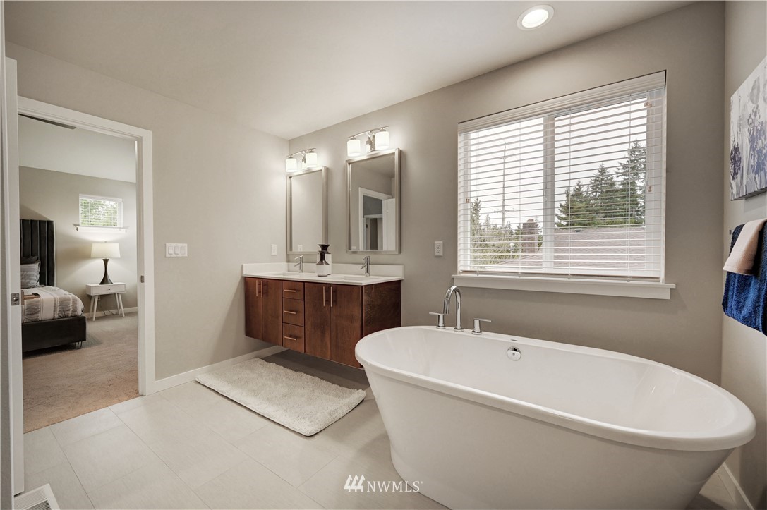 8609 244th Street Southwest, Unit 6 Edmonds, WA 98026 - Photo 13 of 27 a bathroom with a tub a sink and mirror