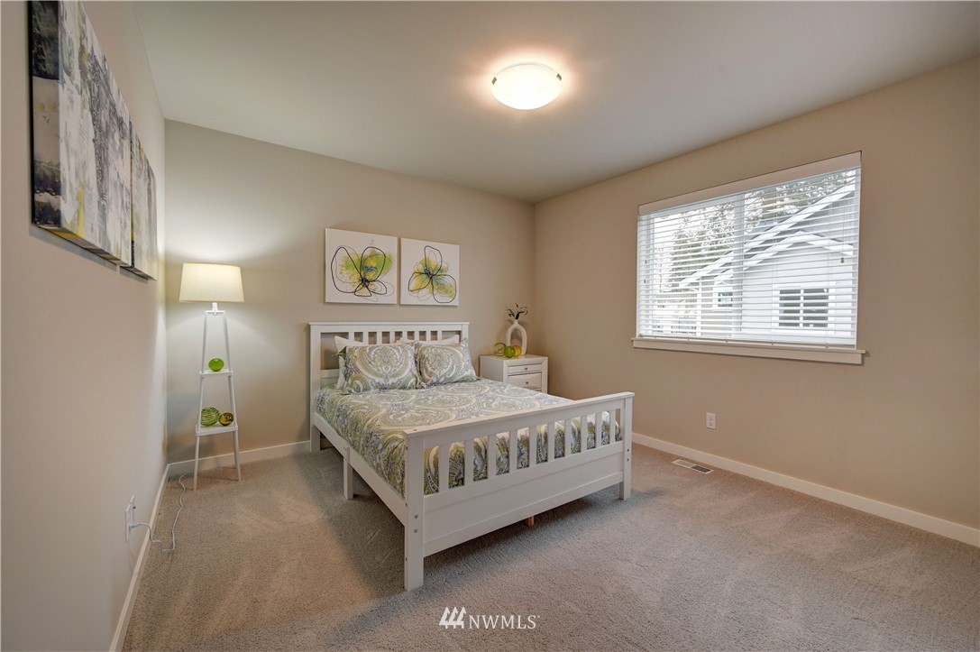 8609 244th Street Southwest, Unit 6 Edmonds, WA 98026 - Photo 15 of 27 a spacious bedroom with a bed and a window