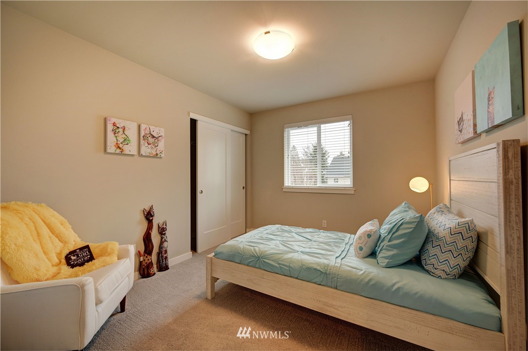 8609 244th Street Southwest, Unit 6 Edmonds, WA 98026 - Photo 16 of 27 a bedroom with a bed couch and window