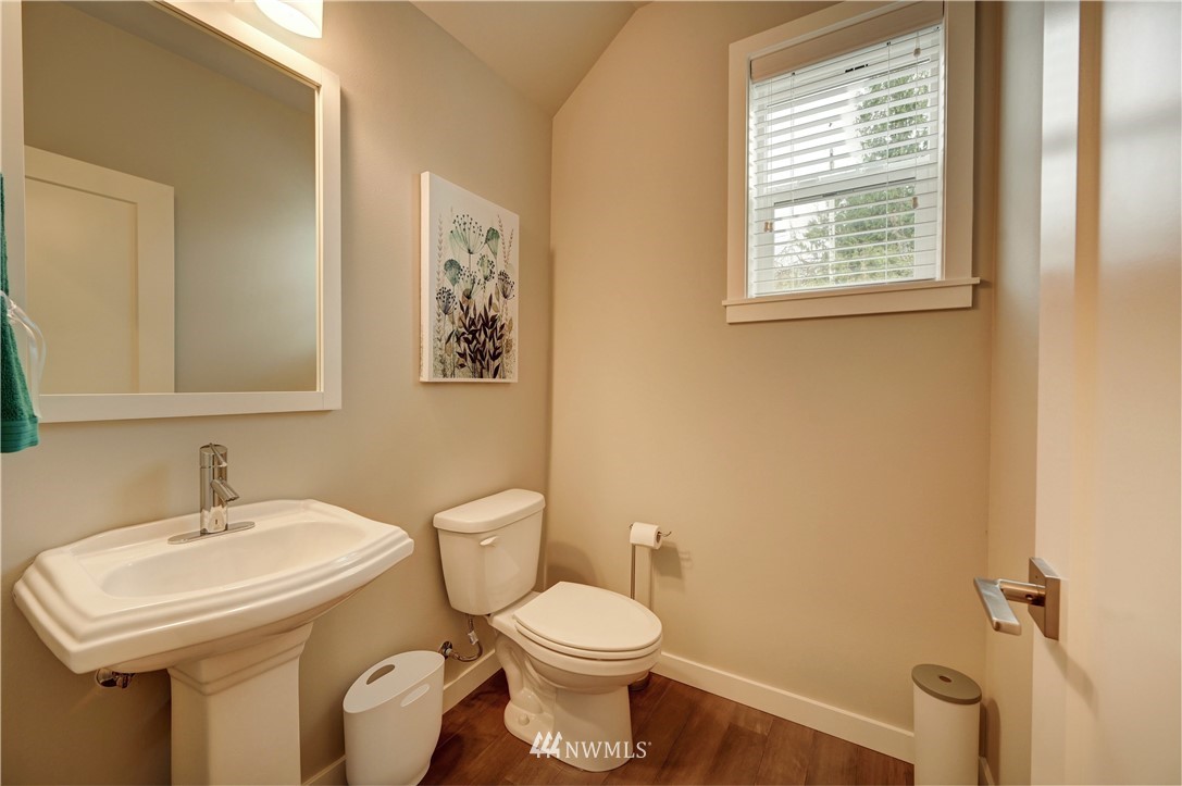 8609 244th Street Southwest, Unit 6 Edmonds, WA 98026 - Photo 18 of 27 a bathroom with a sink toilet and a mirror