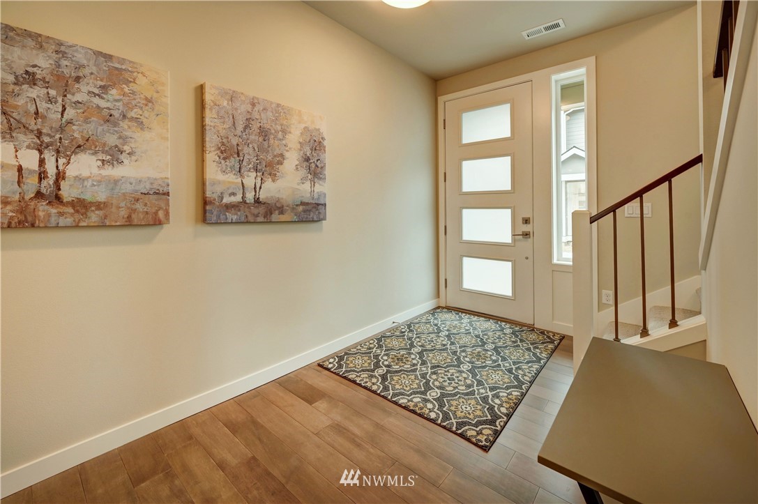8609 244th Street Southwest, Unit 6 Edmonds, WA 98026 - Photo 3 of 27 a view of a bedroom with wooden floor and window