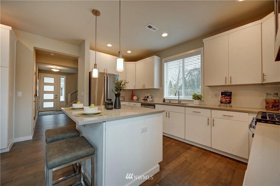 8609 244th Street Southwest, Unit 6 Edmonds, WA 98026 - Photo 4 of 27 a kitchen with counter top space a sink appliances and cabinets