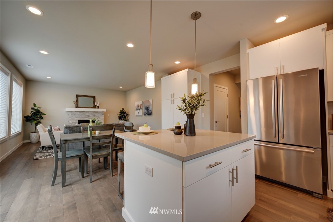 8609 244th Street Southwest, Unit 6 Edmonds, WA 98026 - Photo 6 of 27 a kitchen that has a lot of cabinets a sink and a refrigerator