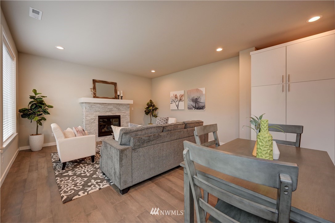 8609 244th Street Southwest, Unit 6 Edmonds, WA 98026 - Photo 7 of 27 a living room with furniture and a fireplace