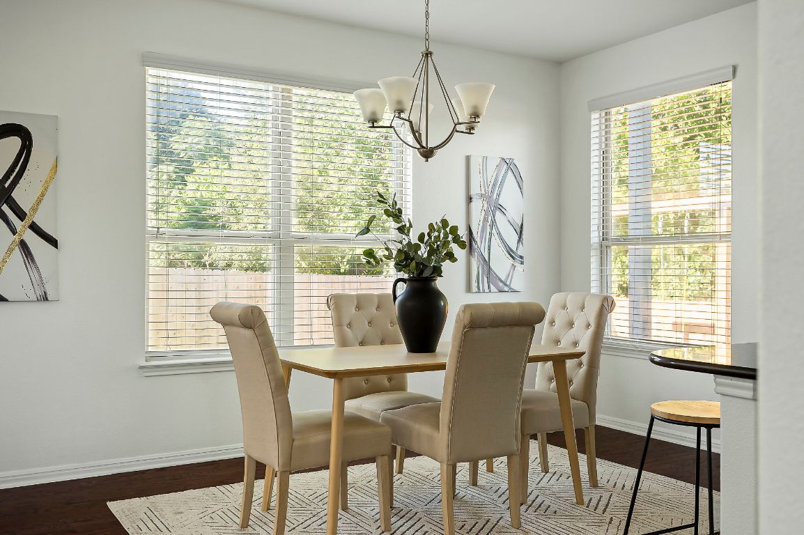 800 Totis Road Austin, TX 78748 - Photo 12 of 29 Dining area featuring plenty of natural light, dark wood-style floors, and a chandelier