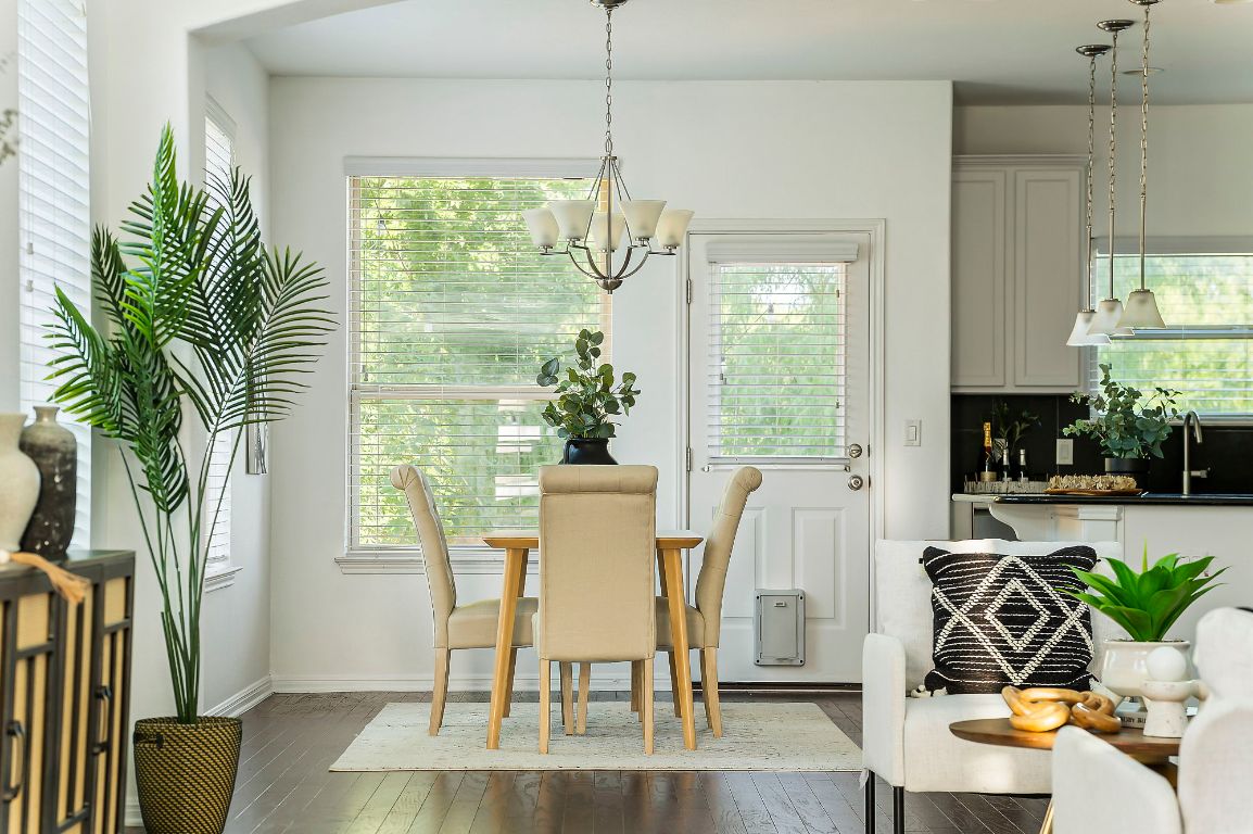 800 Totis Road Austin, TX 78748 - Photo 13 of 29 Dining room with a chandelier, plenty of natural light, and dark wood-type flooring