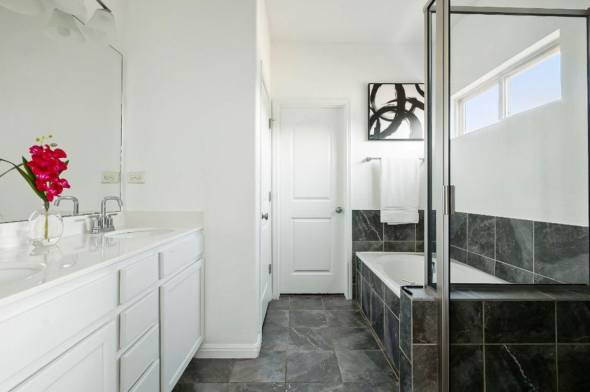800 Totis Road Austin, TX 78748 - Photo 16 of 29 Full bathroom with double vanity, a bath, and a stall shower
