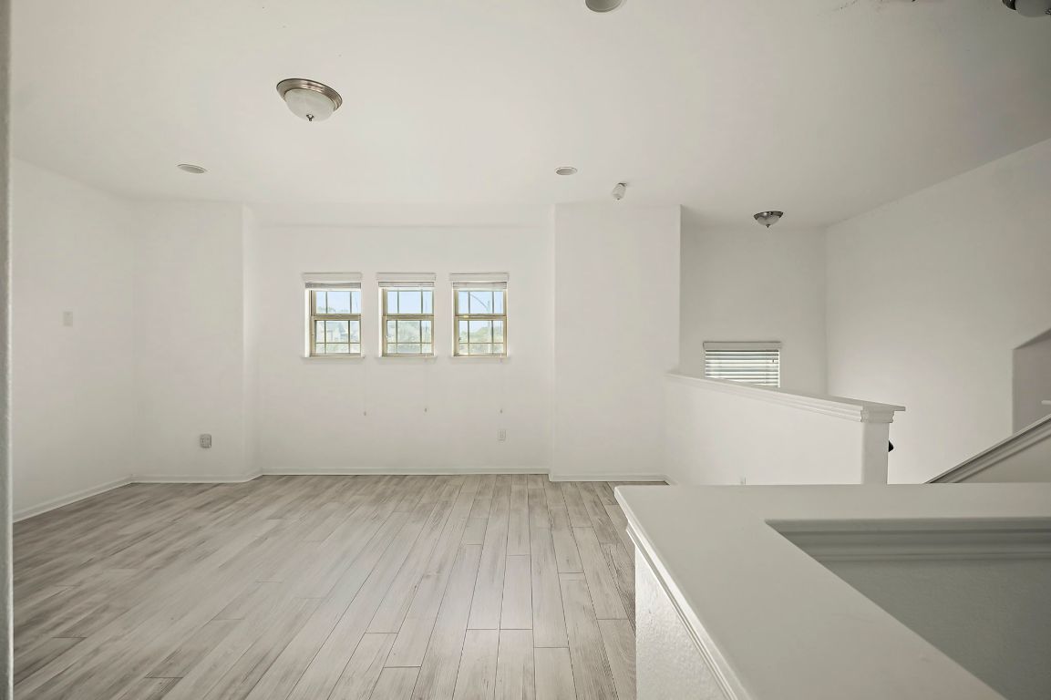 800 Totis Road Austin, TX 78748 - Photo 28 of 29 Unfurnished room with light wood-style floors and baseboards