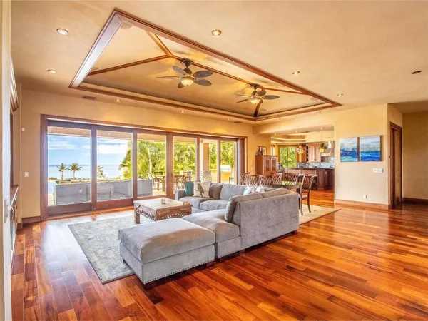 a living room with furniture and large windows