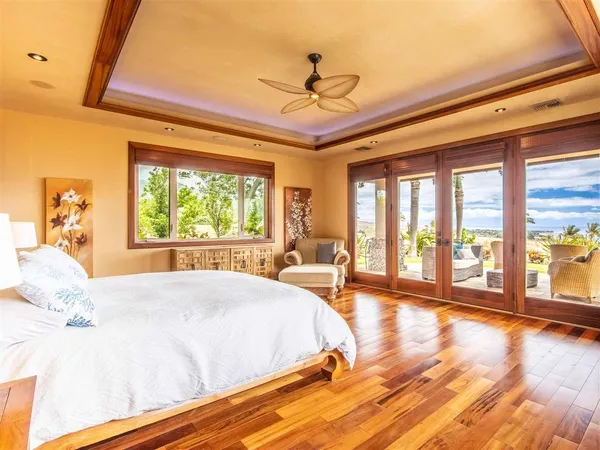 a spacious bedroom with a large bed and a large window