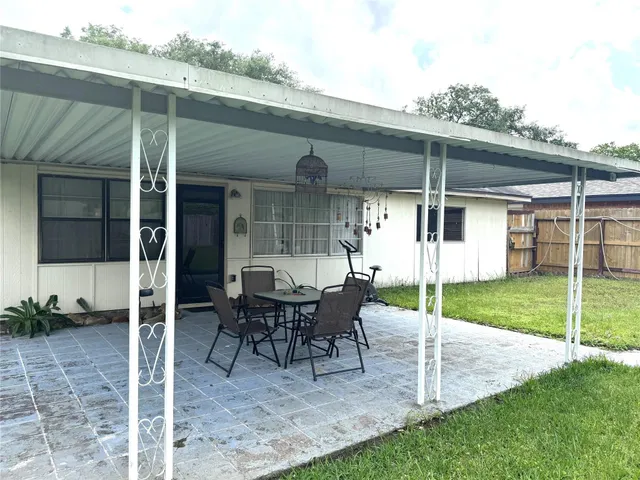 a view of a house with backyard porch and sitting area