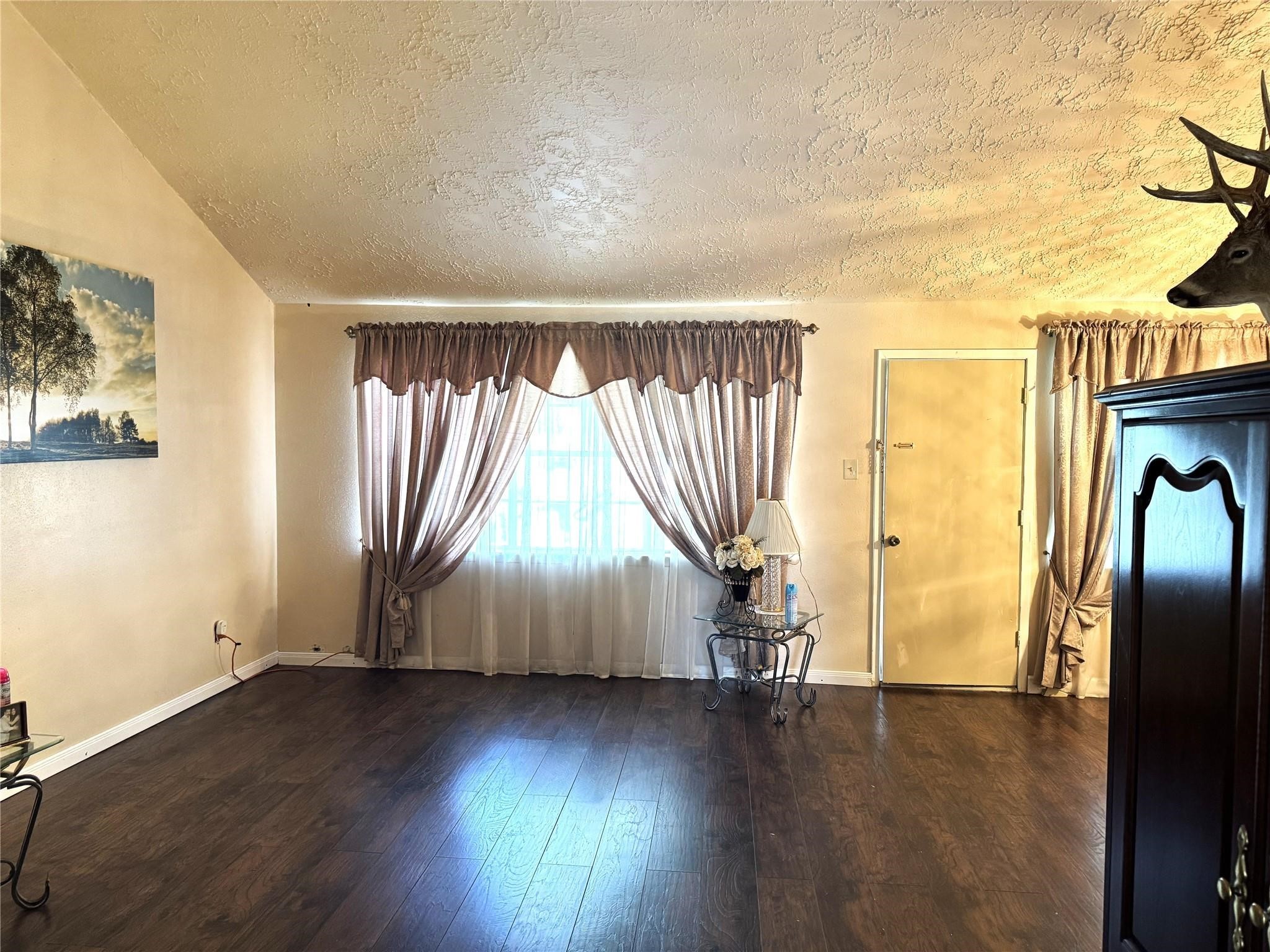 8403 Swan Meadow Lane Humble, TX 77338 - Photo 4 of 13 an empty room with wooden floor and windows