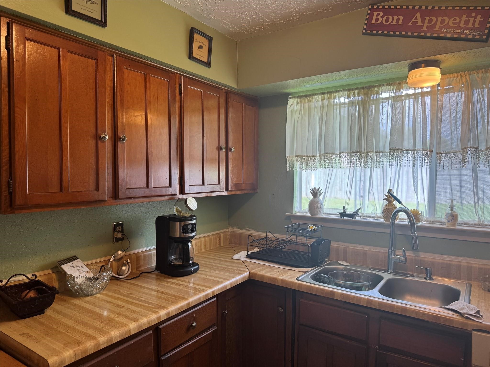 8403 Swan Meadow Lane Humble, TX 77338 - Photo 7 of 13 a kitchen with a sink cabinets and window