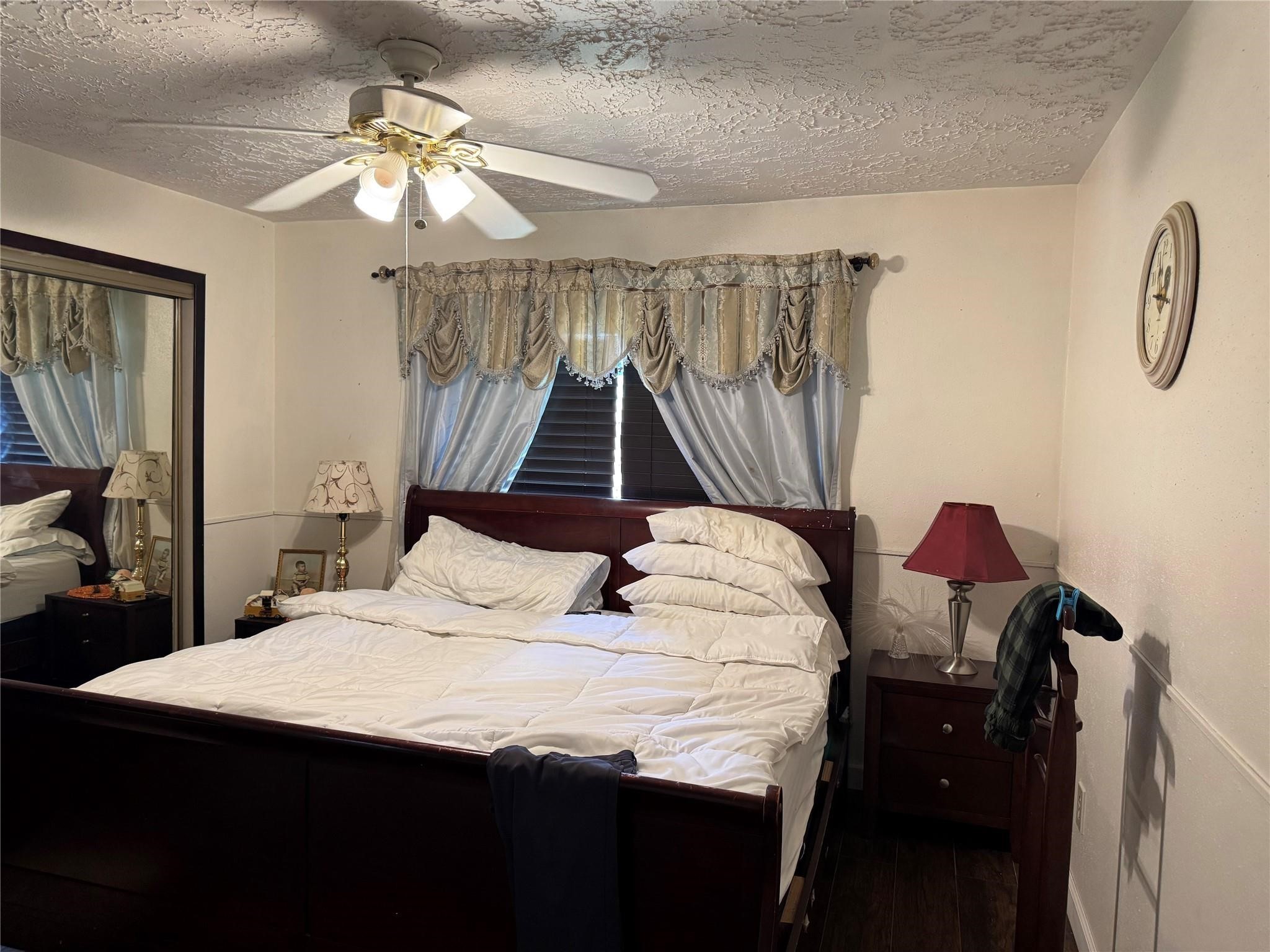 8403 Swan Meadow Lane Humble, TX 77338 - Photo 8 of 13 a bedroom with a bed and a chandelier