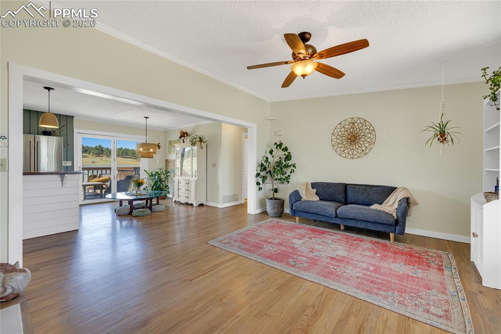 17520 Fremont Fort Road Peyton, CO 80831 - Photo 13 of 42 This inviting living space features hardwood floors, a fireplace, a ceiling fan, built in bookshelves and an open layout