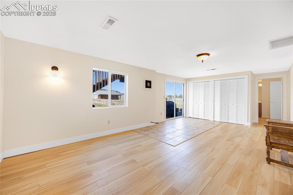 17520 Fremont Fort Road Peyton, CO 80831 - Photo 25 of 42 Spacious interior with light-toned walls, LVP flooring, and a large window providing natural light