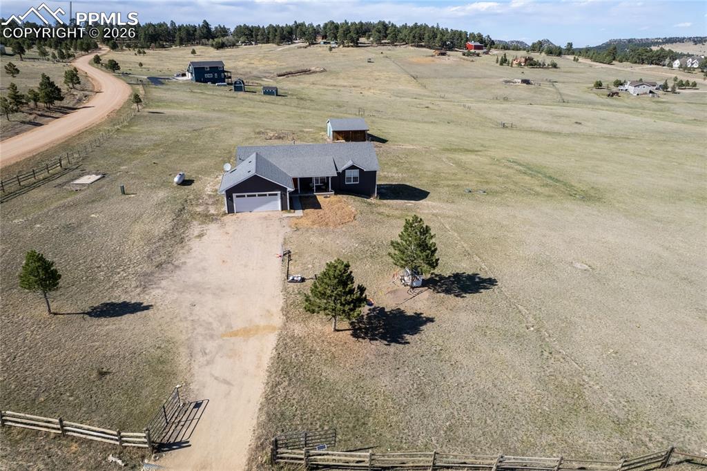 17520 Fremont Fort Road Peyton, CO 80831 - Photo 36 of 42 The property features a ranch-style home with a dark exterior and an attached garage with a white door