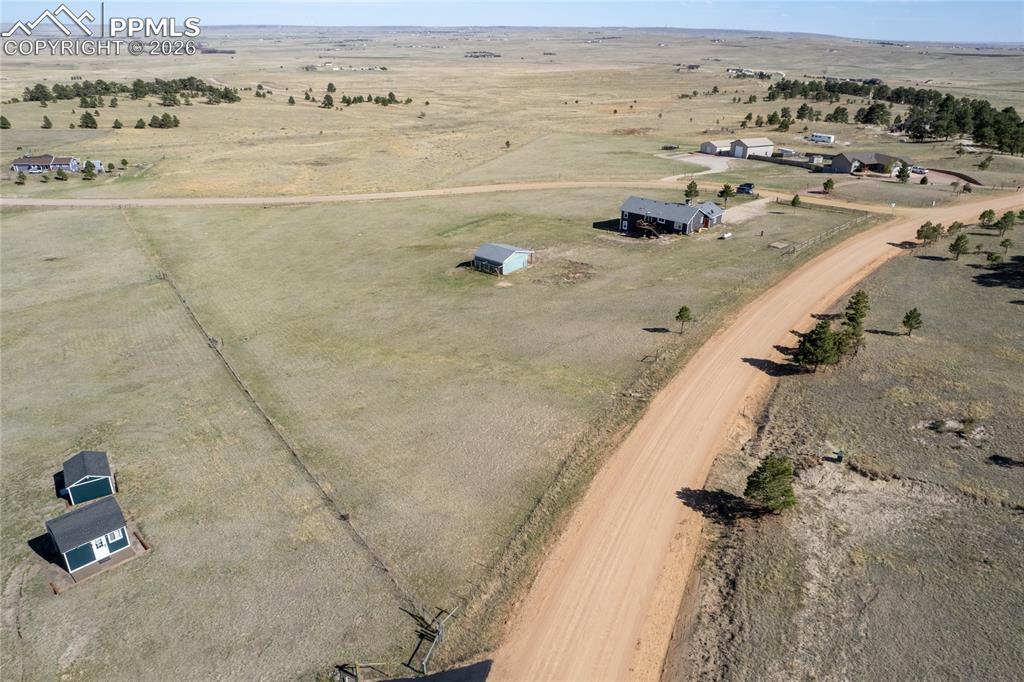 17520 Fremont Fort Road Peyton, CO 80831 - Photo 38 of 42 Aerial view of the property showing a large expanse of land, a main residence with a dark roof and siding, and a barn