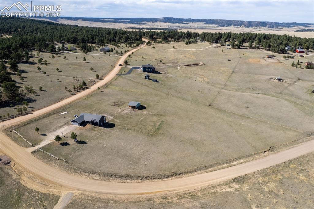 17520 Fremont Fort Road Peyton, CO 80831 - Photo 39 of 42 This property features an expansive lot with a main residence, a detached structure, and a winding dirt road entrance