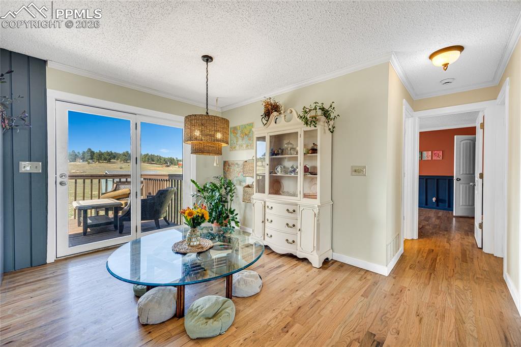 17520 Fremont Fort Road Peyton, CO 80831 - Photo 10 of 42 This room features hardwood floors and a glass door that opens to an outdoor deck