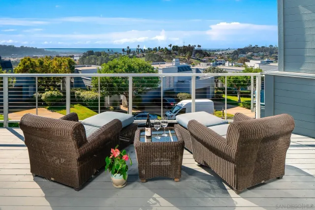 a view of a roof deck with couches and potted plants