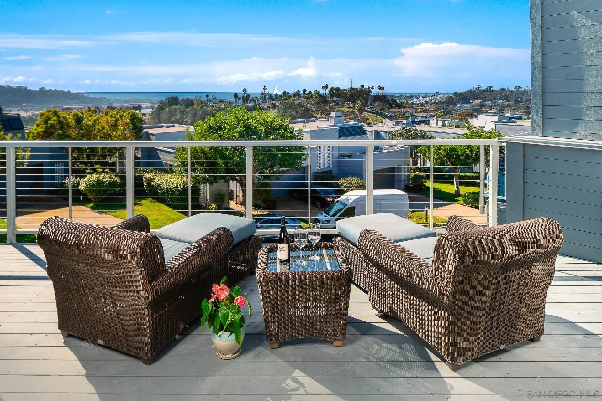 a view of a roof deck with couches and potted plants