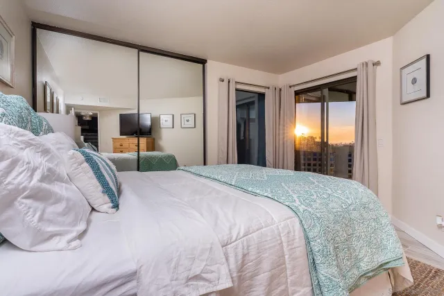 a bedroom with a bed and a flat screen tv