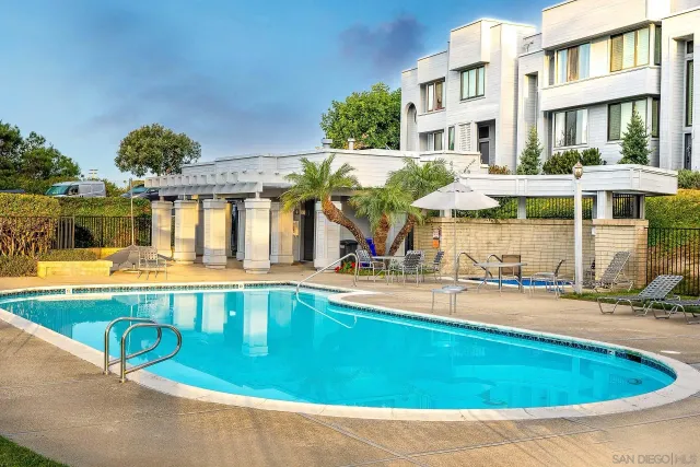 an aerial view of a house with swimming pool outdoor seating and yard