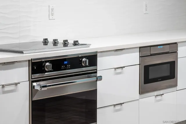 a stove top oven sitting inside of a kitchen