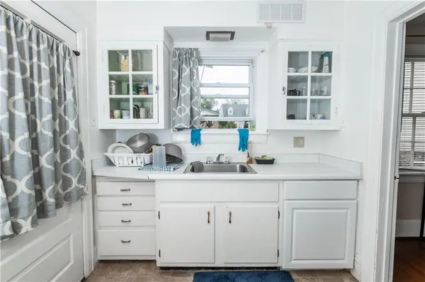a kitchen with cabinets and window