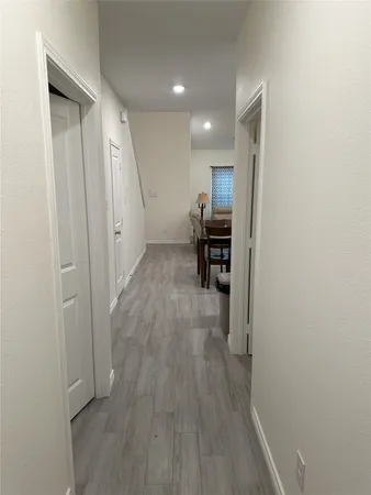 a view of hallway with wooden floor