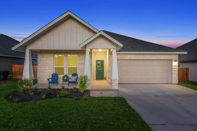 a front view of house with yard and outdoor seating
