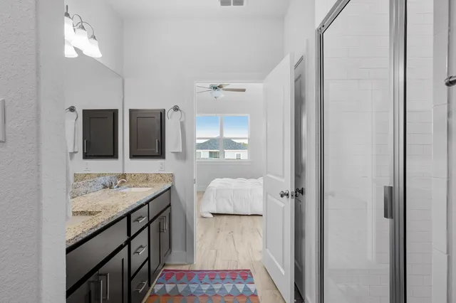 a bathroom with a granite countertop sink and a mirror