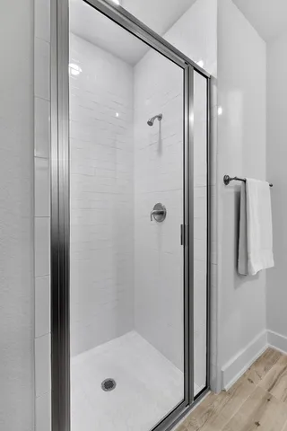 a bathroom with a glass shower door