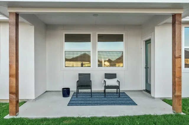 a living room with a rug and a table